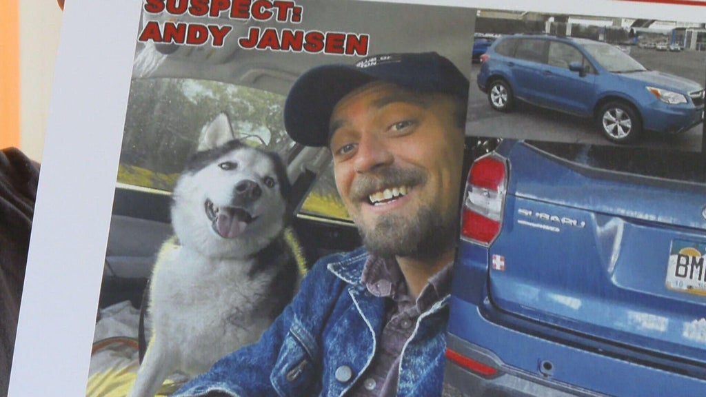A grieving dog owner holding a photo of their deceased pet.